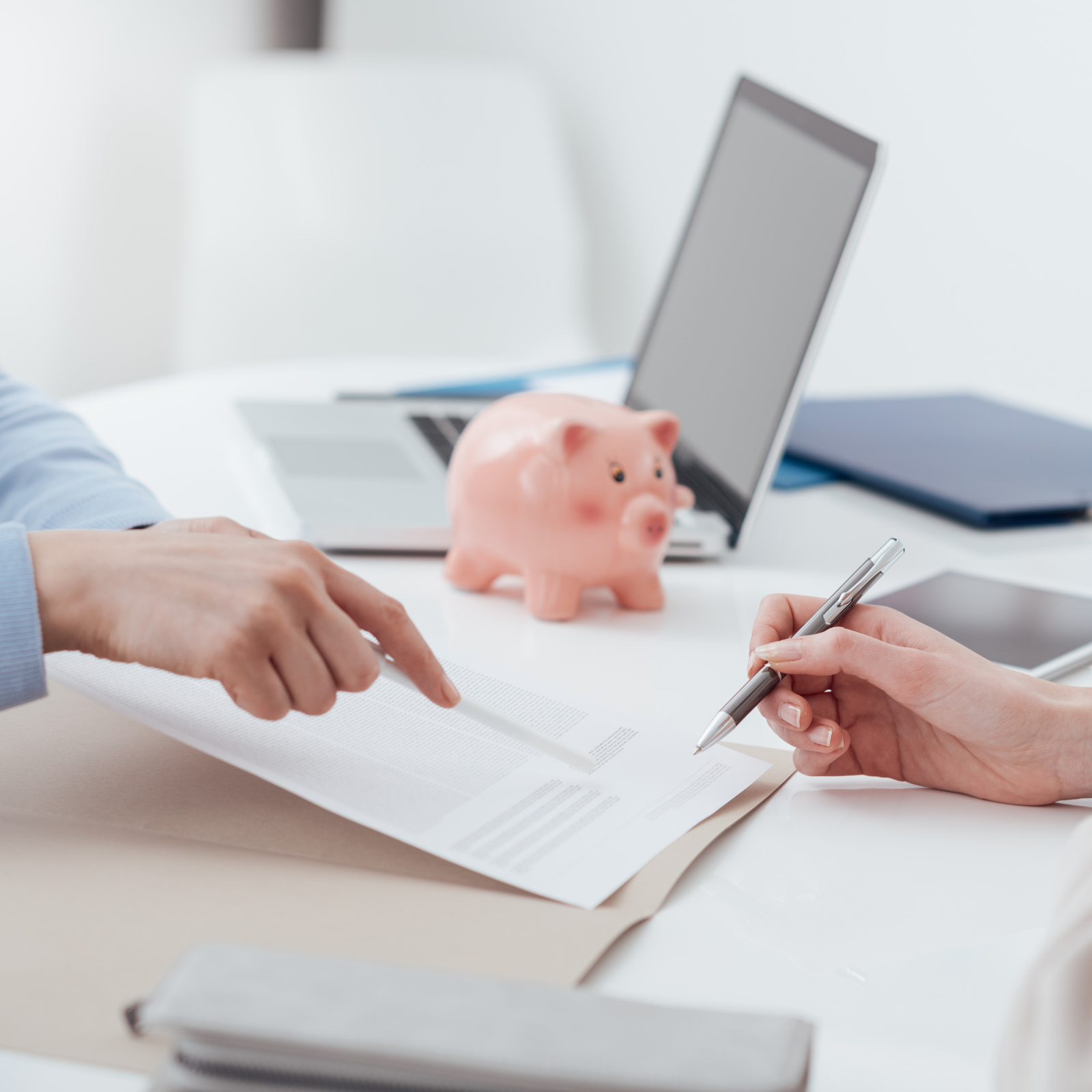 Financial Planning and Insurance Reviews for Family Security Financial planning session with documents, laptop, and piggy bank - insurance review for family financial security.