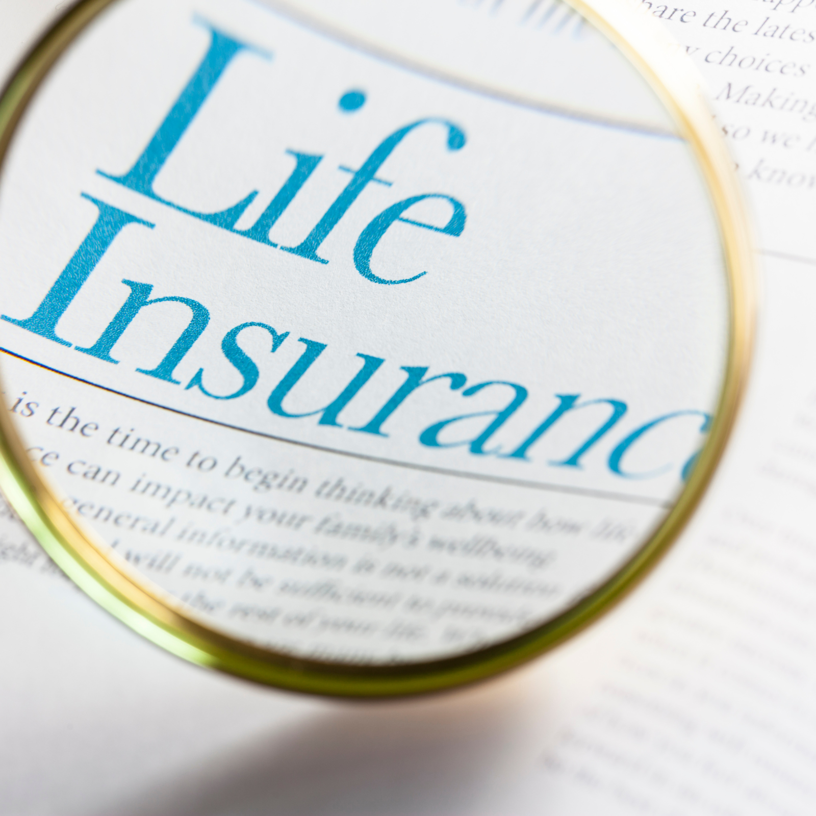 The Role of Life Insurance in Wealth-Building Strategies "Magnifying glass highlighting the words 'Life Insurance' on a policy document, representing financial security and planning."
