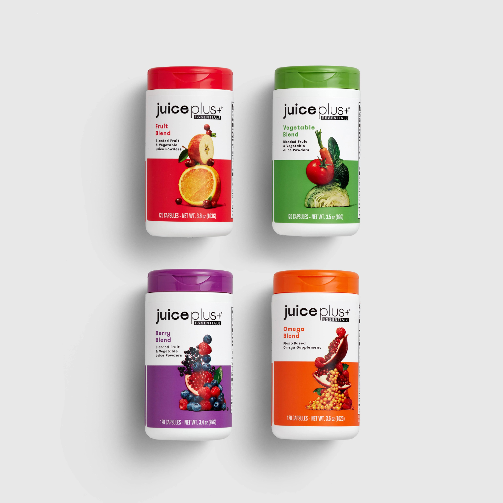 Four Juice Plus Essentials supplement bottles—Fruit Blend (red), Vegetable Blend (green), Berry Blend (purple), and Omega Blend (orange)—on a white background.
