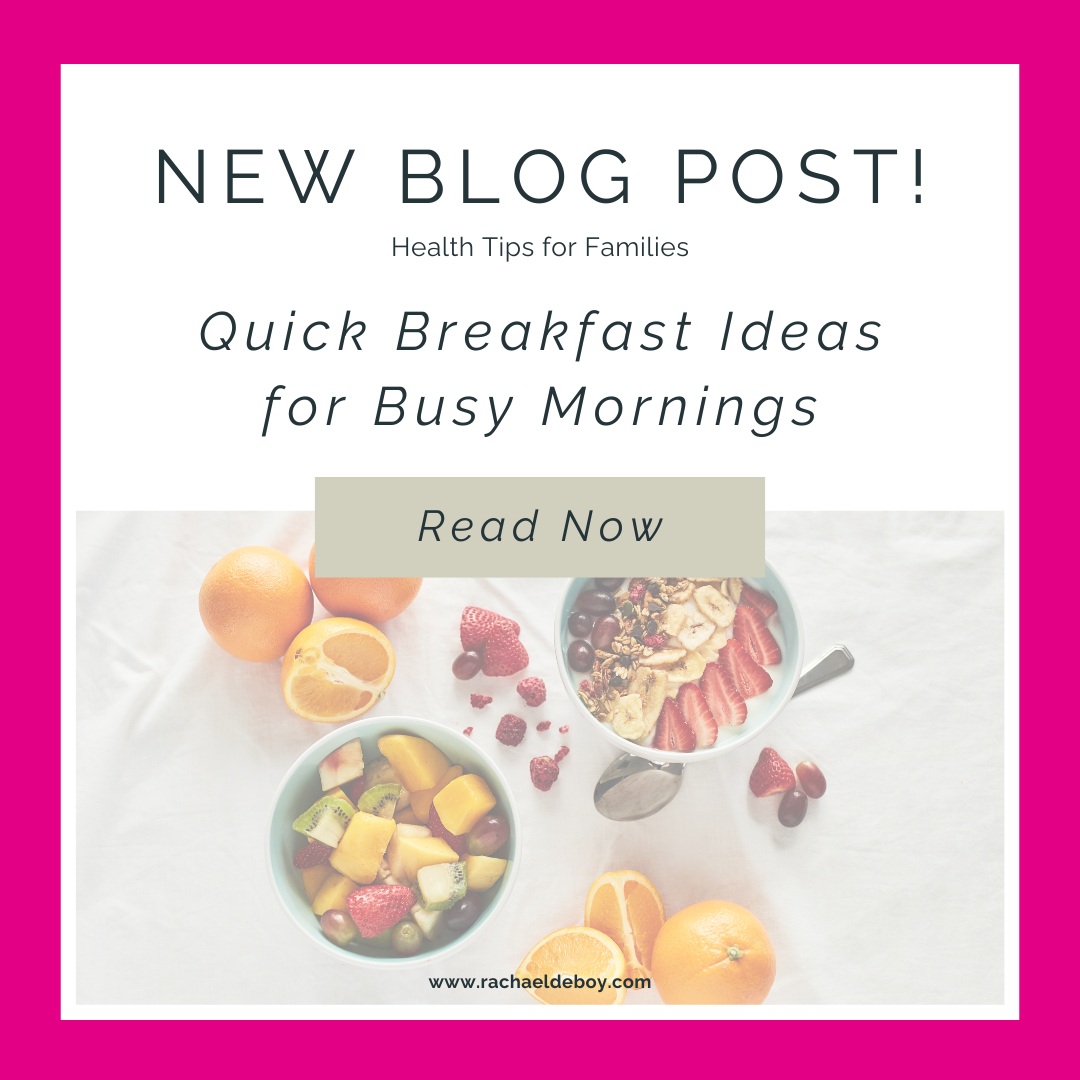 Flat lay of colorful bowls filled with fruit and smoothie bowls on a white table with sliced oranges