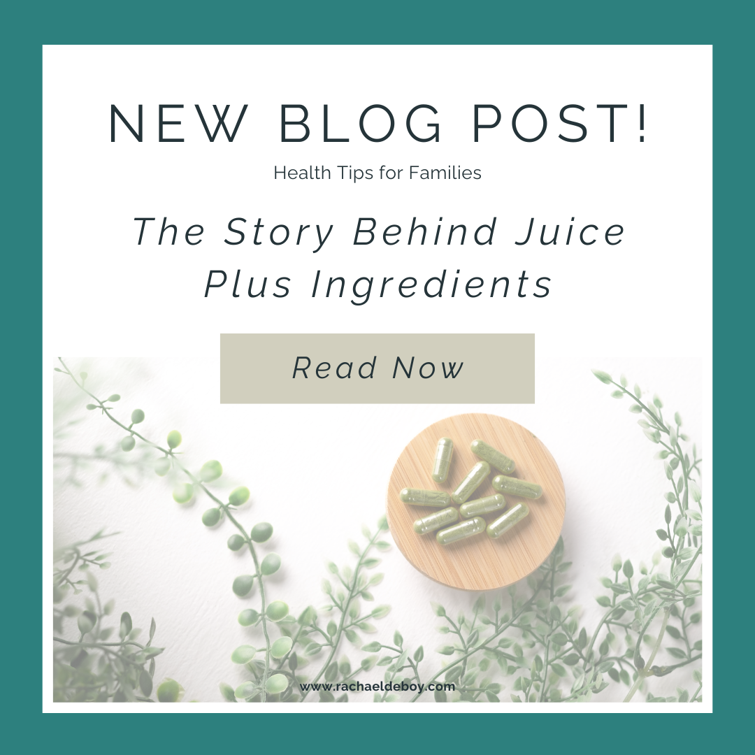 Flat lay of green Juice Plus capsules on a bamboo plate surrounded by fresh greenery, promoting an updated blog post on family wellness supplements.