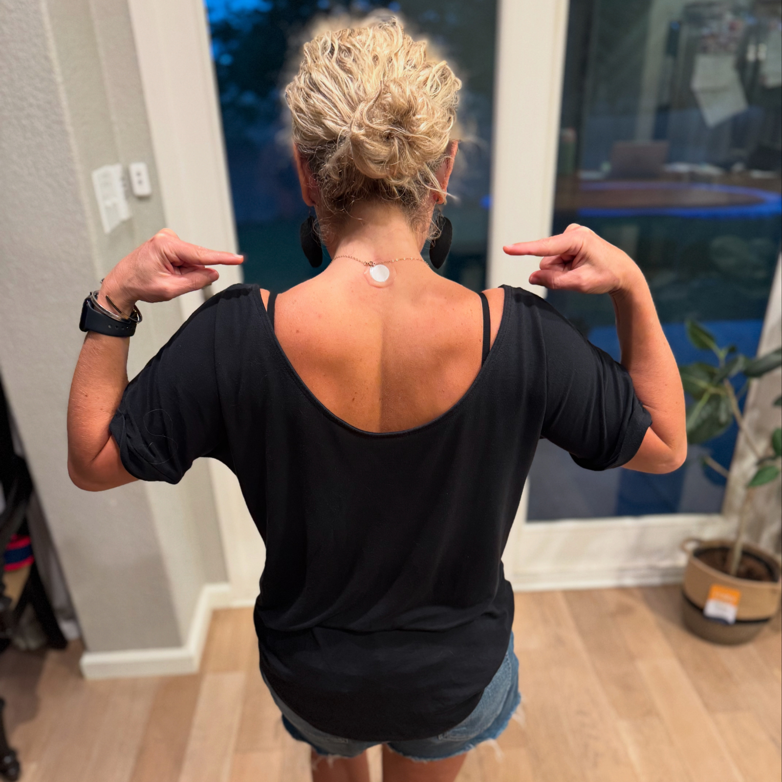 Demonstration of LifeWave X39 patch placement on upper back by Rachael DeBoy Wellness in San Antonio, Texas.